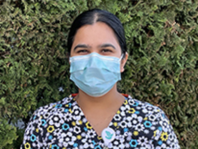 Image of woman in scrubs mask